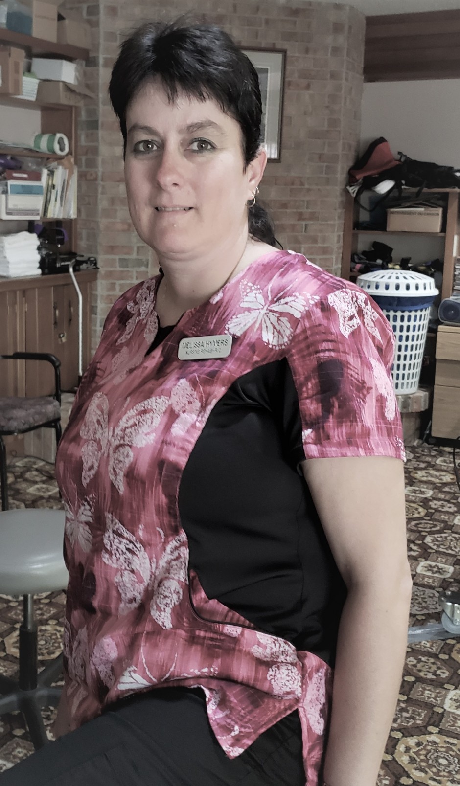 Portrait of personal support worker in pink butterfly print uniform